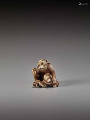 AN IVORY NETSUKE OF A MONKEY GROOMING HIS YOUNG BY…