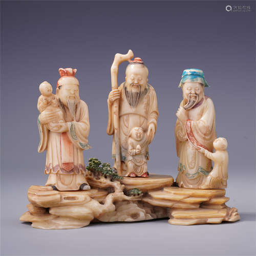 THREE SOAPSTONE CARVED FIGURES WITH BOYS