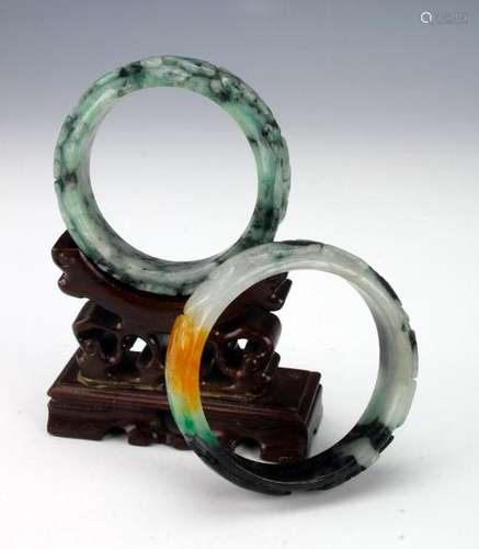 TWO CARVED JADE BANGLES