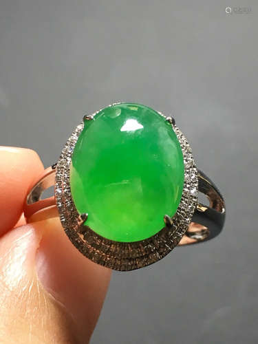 A GREEN JADEITE CARVED CIRCLE FINGER RING