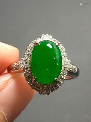 A GREEN JADEITE CARVED CIRCLE FINGER RING