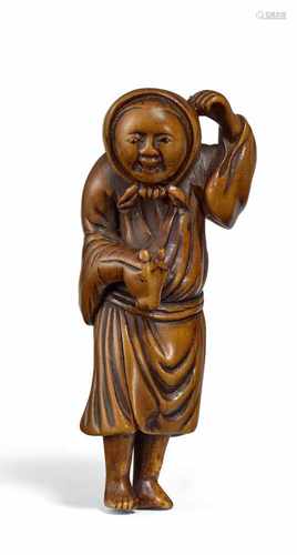 NETSUKE: GAUKLER MIT PFERDEKOPF-HANDPUPPE. Japan. Edo-Zeit. 18./19. Jh. Buchsbaum. Sich mit der