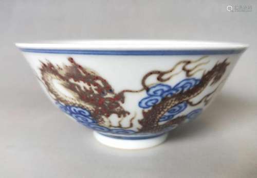 AN IRON-RED BLUE AND WHITE 'DRAGON' BOWL.MARK OF