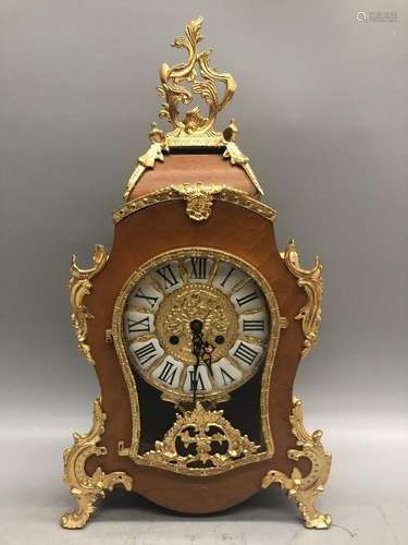 A GILT-BRONZE WOOD CLOCK.