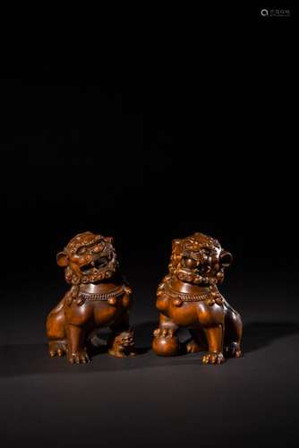 A PAIR OF CARVED HUANGYANMU LIONS.ANTIQUE