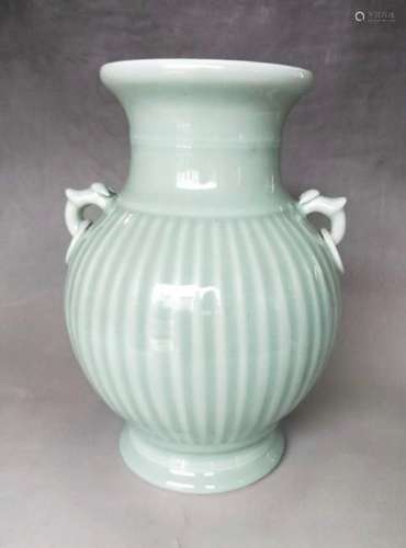 A CARVED CELADON-GLAZED VASE.MARK OF YONGZHENG