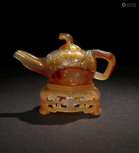 AN AMBER MELON-SHAPED TEAPOT WITH BASE