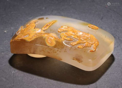AN AMBER BELT BUCKLE WITH CARVING