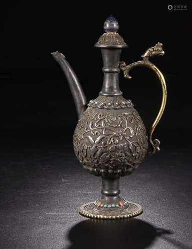 A SILVER EWER WITH FLOWER PATTERN