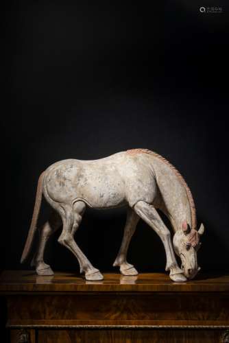 A PAINTED POTTERY FIGURE OF A HORSE