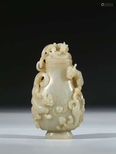 A RARE WHITE AND RUSSET JADE CARVED 'CHILONG' VESSEL