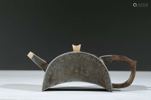 A PEWTER 'INSCRIBED' CRESCENT SHAPED TEAPOT