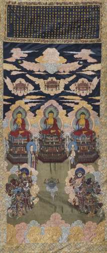 A SILK EMBROIDERED 'THREE BUDDHAS' INSCRIBED THANGKA