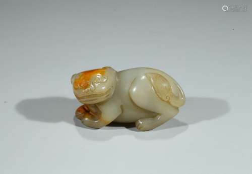 A CELADON JADE CARVED MYTHICAL BEAST