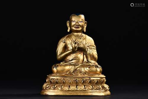 A GILT-BRONZE FIGURE OF GURU