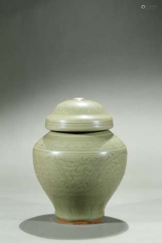 A CELADON CARVED JAR AND COVER