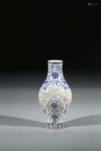 A BLUE AND WHITE SASH TIED VASE