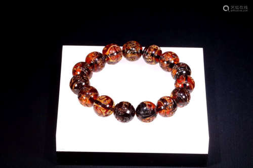 AN AMBER BRACELET WITH DRAGON PATTERNS