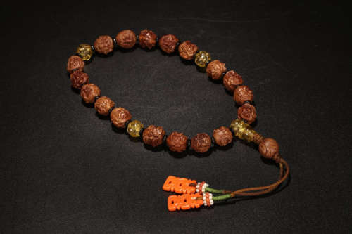 A WALNUT BRACELET WITH ARHAT CARVED