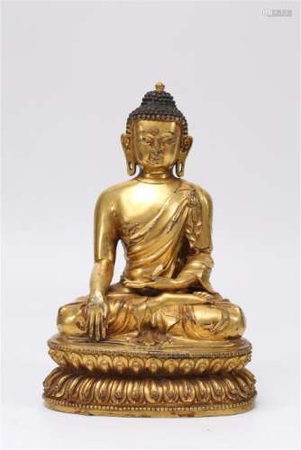 A GILT-BRONZE FIGURE OF SAKYAMUNI.MING DYNASTY