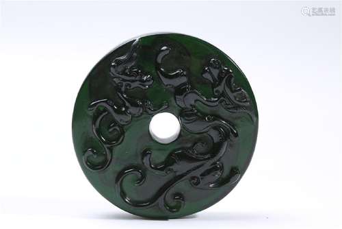 A CARVED GREEN GLASS DRAGON BI.ANTIQUE