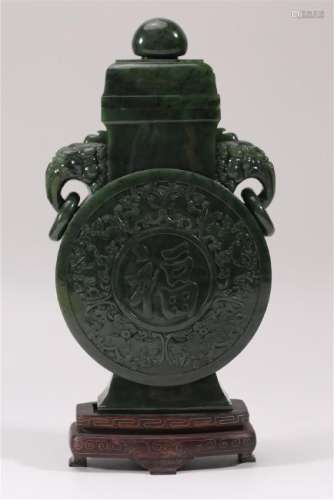 A CARVED SPINACH-GREEN JADE VASE AND COVER.