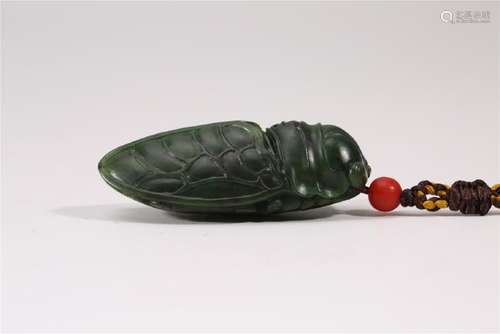 A CARVED SPINACH-GREEN JADE CICADA.