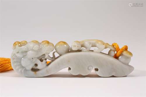 A CARVED JADEITE DRAGON BELT-HOOK.