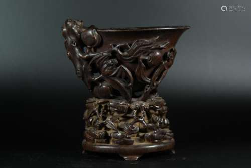 A CARVED AGALLOCH WOOD 'PEACHS'CUP AND STAND.ANTIQUE