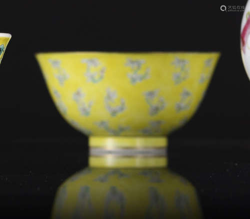 A YELLOW-GLAZED PORCELAIN BOWL WITH ORCHIDS