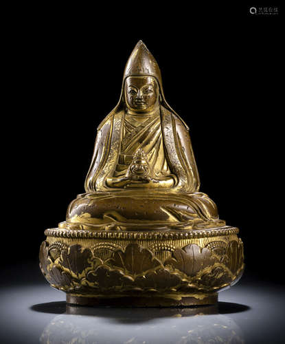 A GILT-BRONZE FIGURE OF A GELUGSPA LAMA