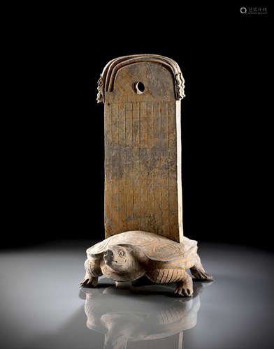 AN UNUSUAL AND RARE GREY EARTHENWARE STELE WITH A TURTLE STAND