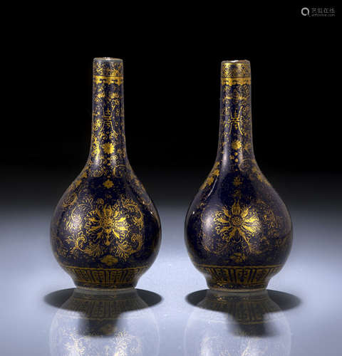 A PAIR OF POWDERLUE-GROUND GILT PAINTED PORCELAIN BOTTLE VASES