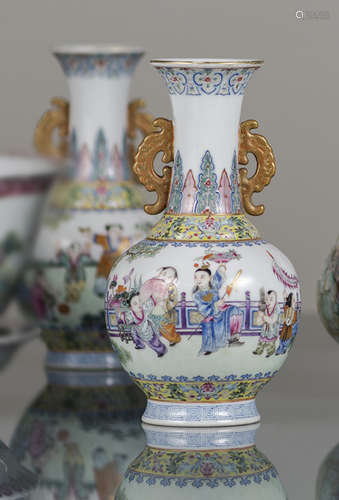 A PAIR OF HANDLED FAMILLE ROSE 'PLAYING CHILDREN' VASES