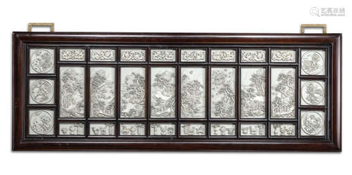 A FINE CARVED IVORY TABLE SCREEN MOUNTED IN A WOODEN FRAME UNDER GLASS