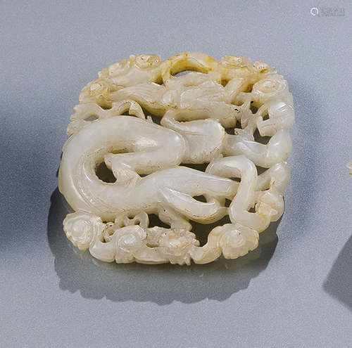 A JADE CARVING OF A DRAGON AND CLOUDS