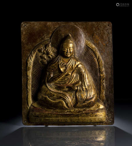 A GILT-COPPER PLAQUE EMBOSSED WITH A LAMA