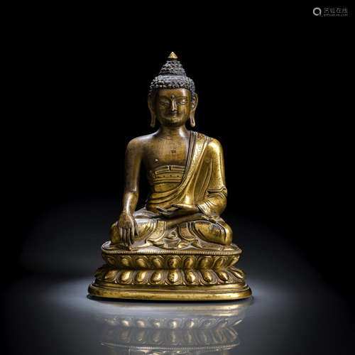 A PARCEL GILT-BRONZE FIGURE OF BUDDHA SHAKYAMUNI