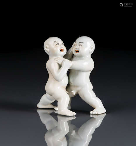 A PORCELAIN GROUP OF TWO WRESTLING BOYS