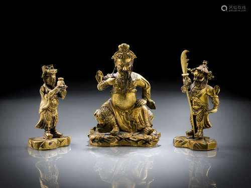 A FINE GILT-BRONZE FIGURE OF SEATED GUANDI AND HIS CONSORTS