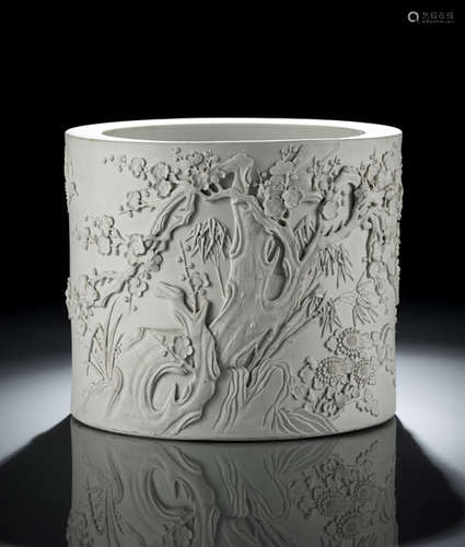 A MOLDED BISCUIT PORCELAIN BRUSHPOT WITH PLUM BLOSSOMS