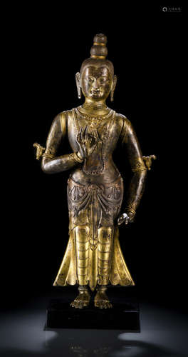 AN EMBOSSED GILT-BRONZE FIGURE OF A BODHISATTVA