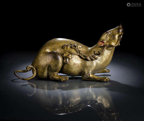 A FINE AND RARE GILT BRONZE MONGOOSE HOLDING A PEACH BRANCH