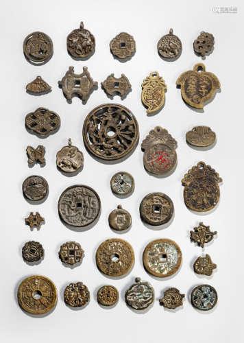 A GROUP OF 35 BRONZE AND METAL COINS AND PENDANTs