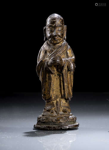 A GILT-LACQUERED BRONZE FIGURE OF STANDING ANANDA