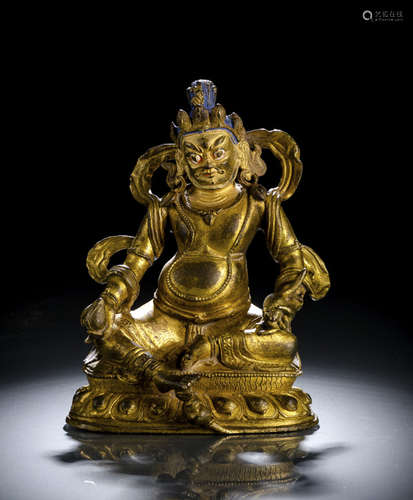 A GILT-BRONZE FIGURE OF JAMBHALA