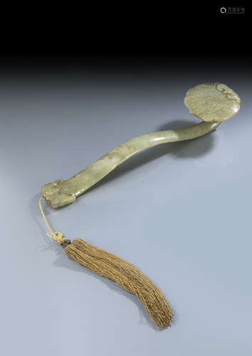 A WELL CARVED GREEN AND CARAMEL COLORED JADE SCEPTER WITH BATS AND BIRD MOTIFS