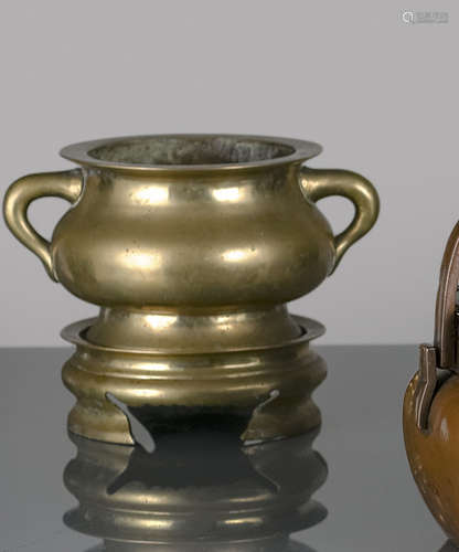 A BRONZE CENSER ON A CIRCULAR STAND