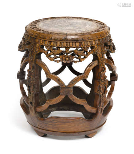 A DRUM-SHAPED HARDWOOD STOOL WITH FLOWER CARVING