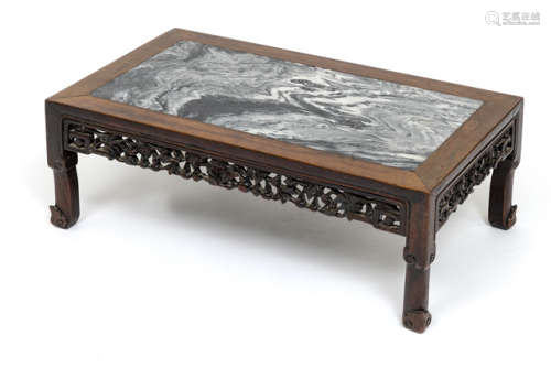 A LOW HARDWOOD TABLE WITH MARBLE TOP